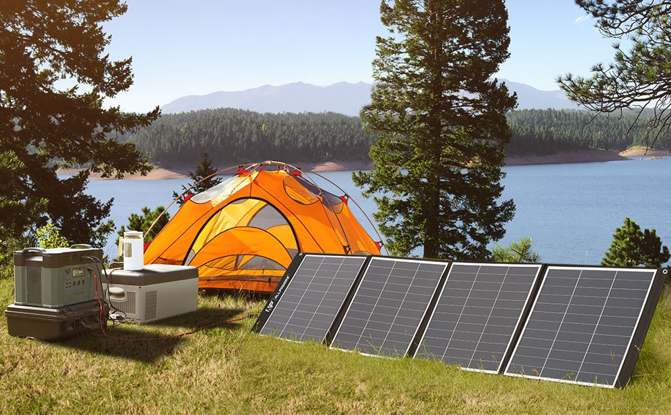 Solar generator kit with folding panels powering a lakeside campsite