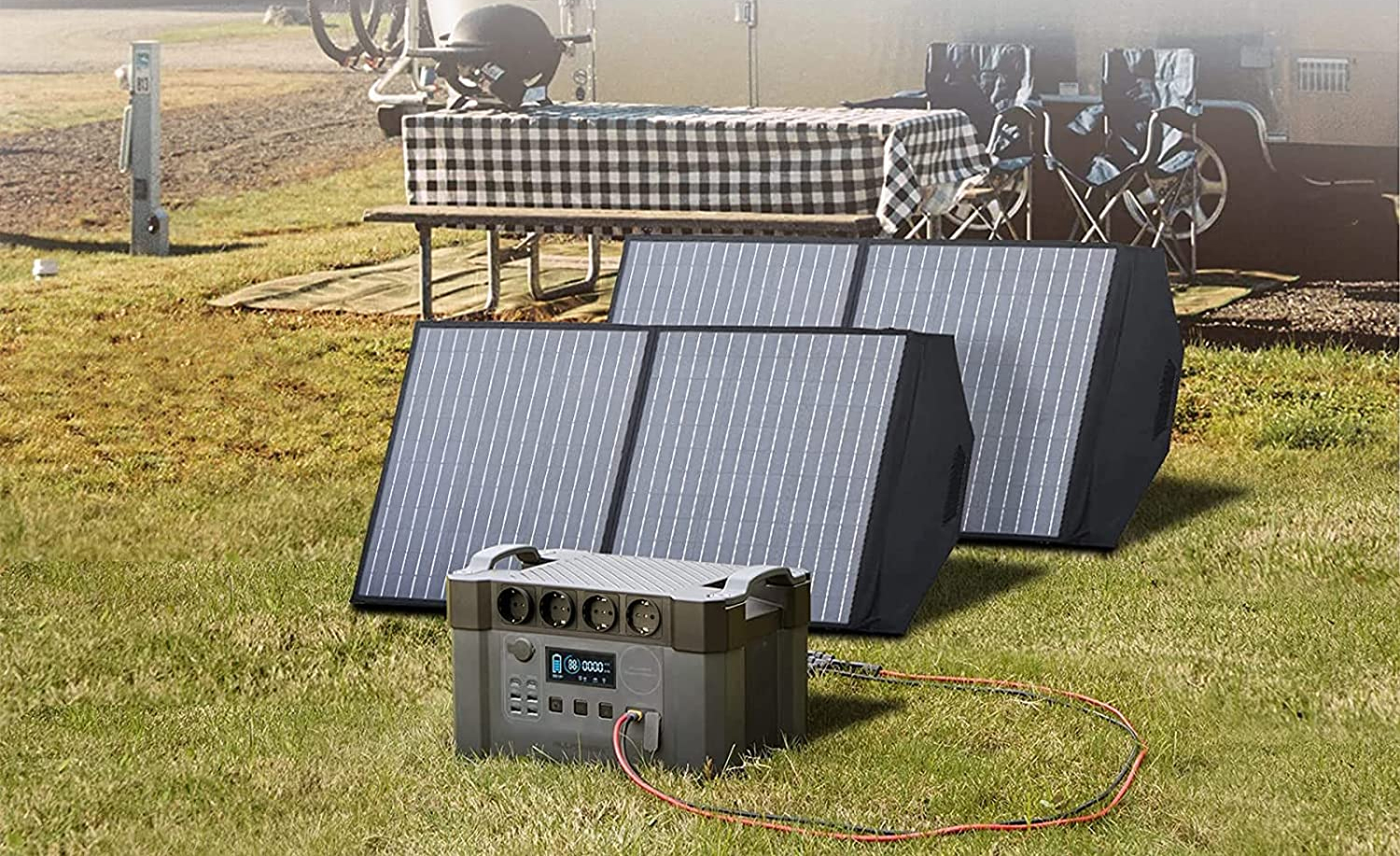 Solar generator with folding solar panels charging at a campsite